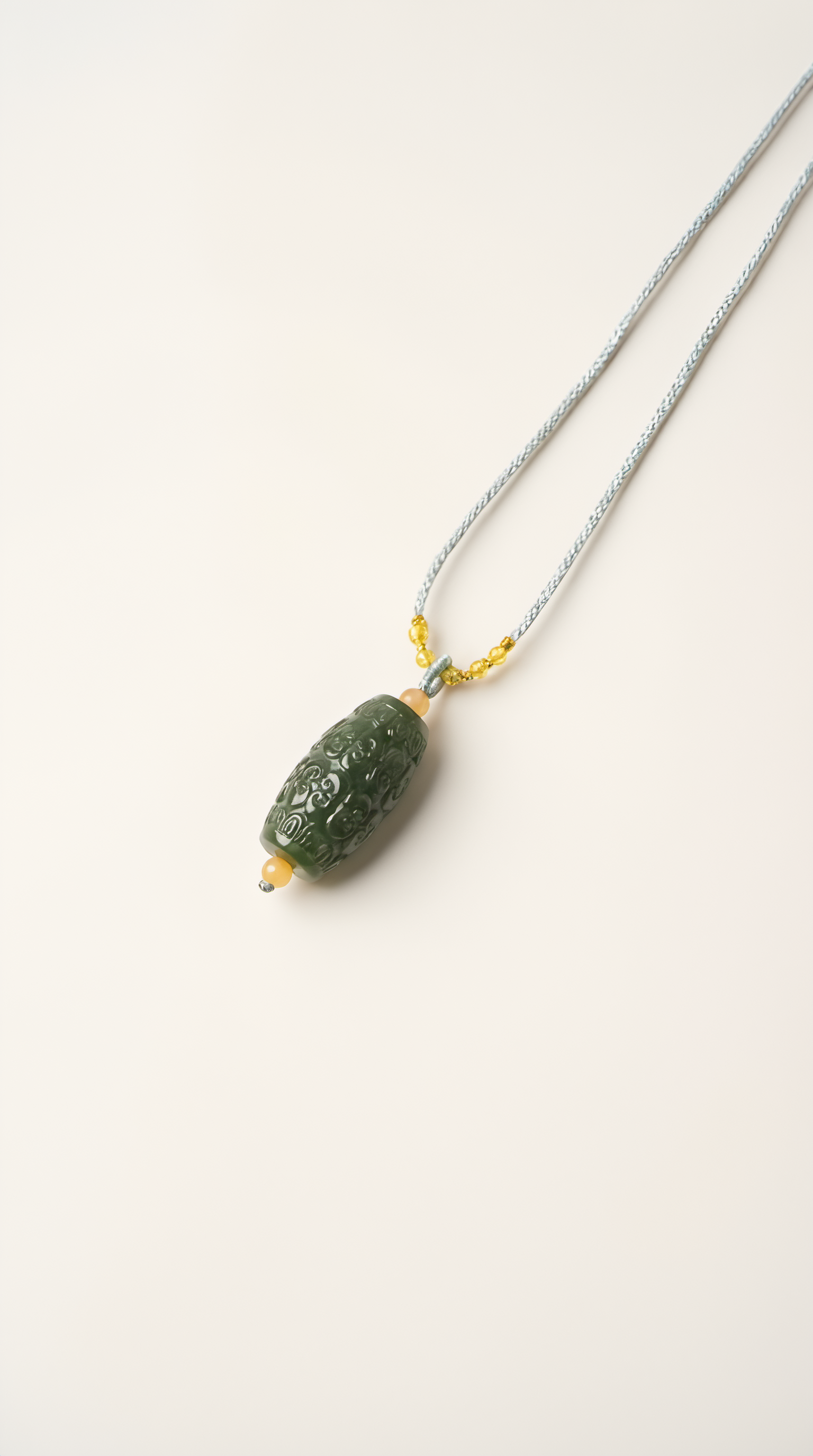 Green nephrite jade barrel pendant necklace close-up detail