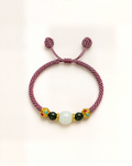 Flor de Luz features a dusty mauve-pink hand-braided silk cord and a rounded white/grey nephrite jade centre bead.