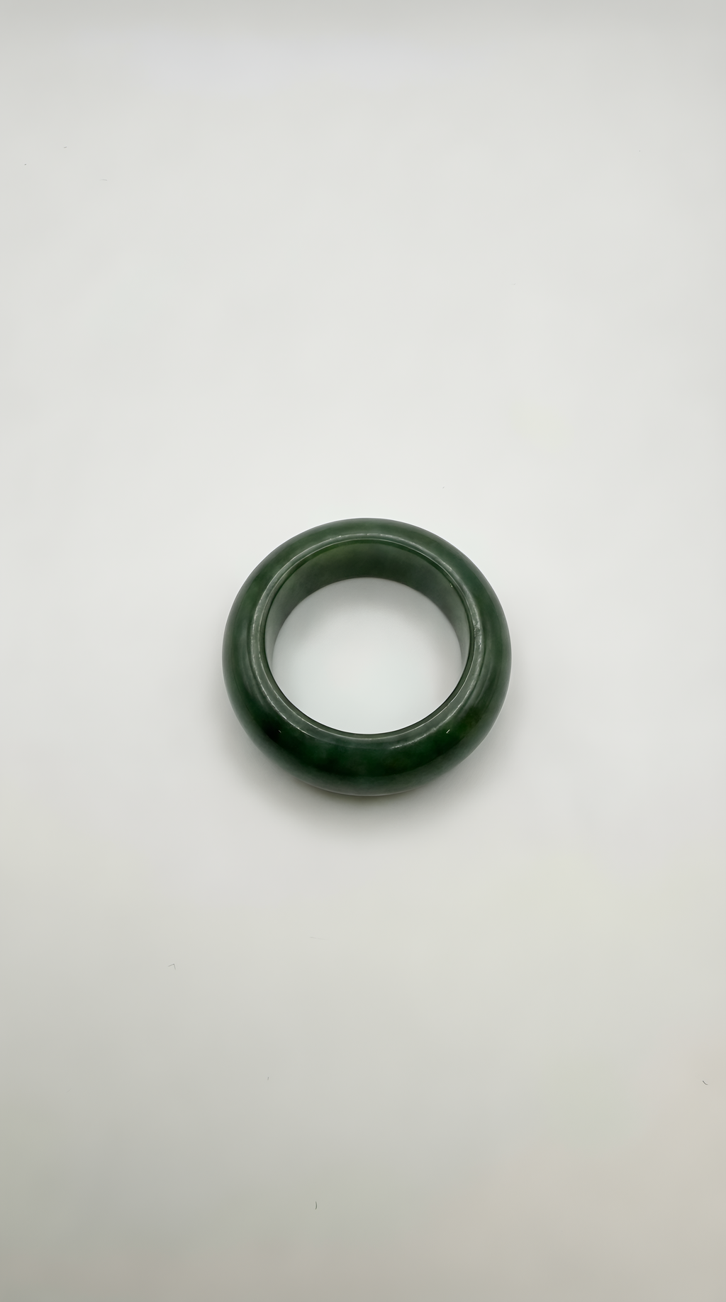 Green jade dome ring close-up showing polished cabochon