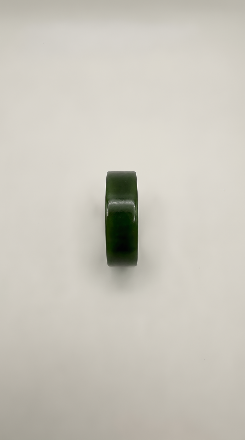 Green jade flat band ring detail showing natural stone colour