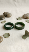 Green jade ring pair showing dome and flat band styles together