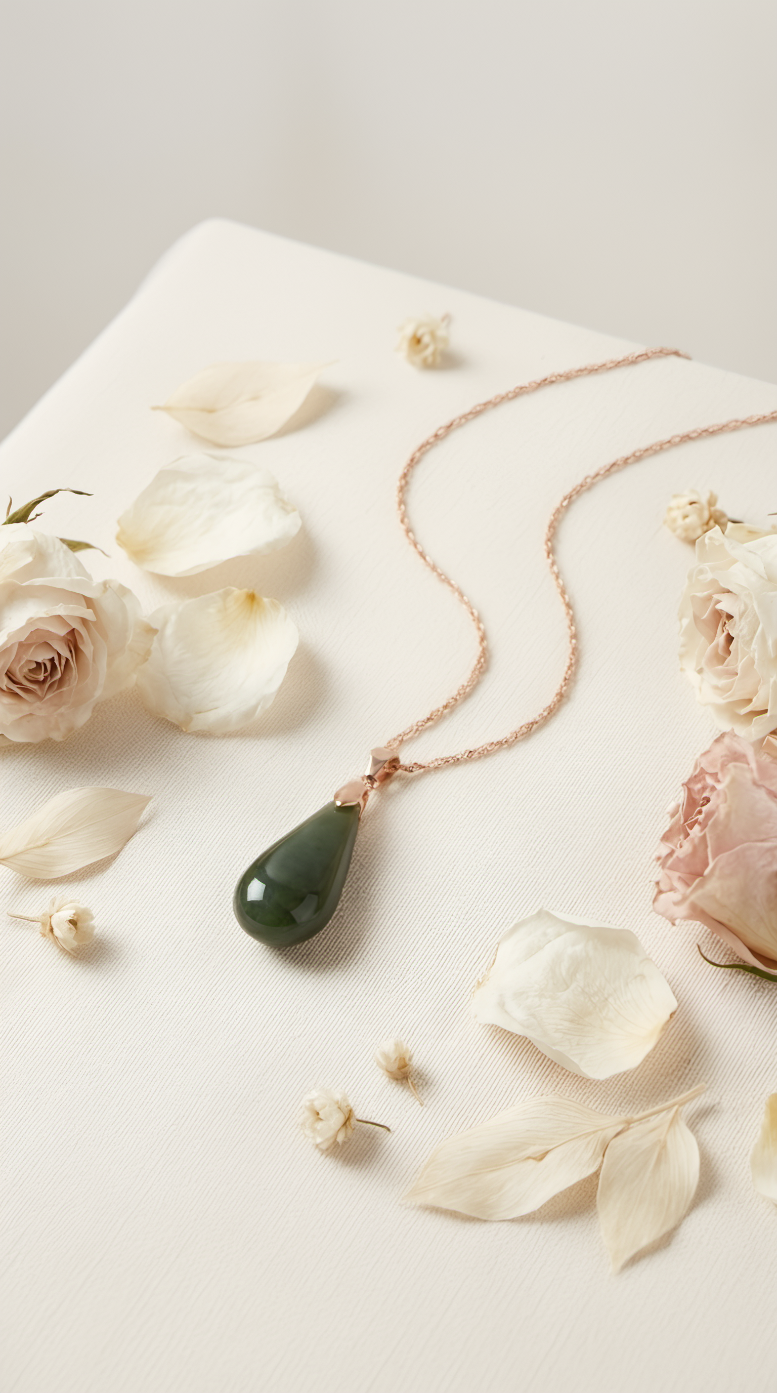 Nephrite jade teardrop pendant necklace lifestyle photo on plate