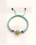 Marea pairs a yellow nephrite jade centre bead with small blue aquamarine and red ruby beads.