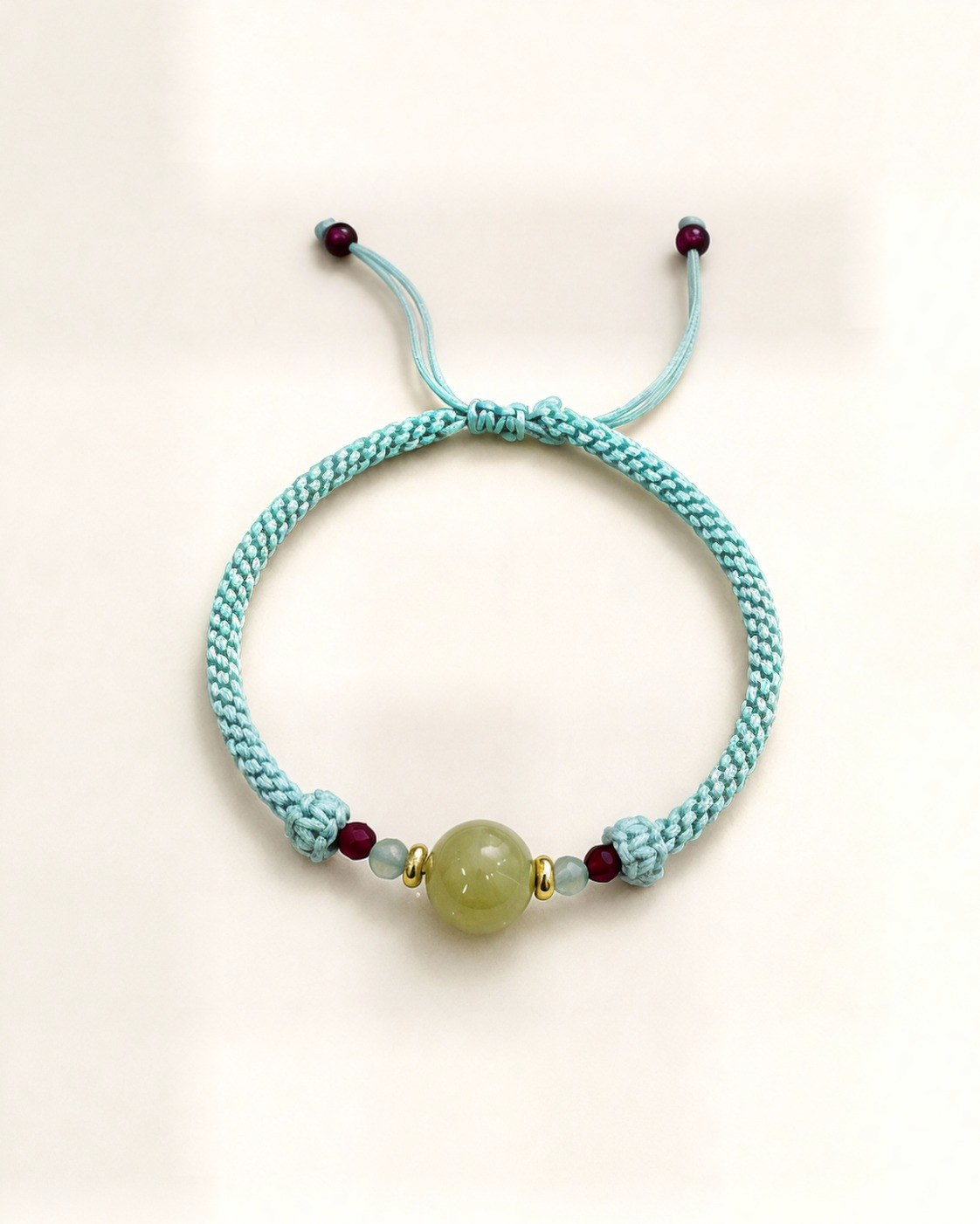 Marea pairs a yellow nephrite jade centre bead with small blue aquamarine and red ruby beads.