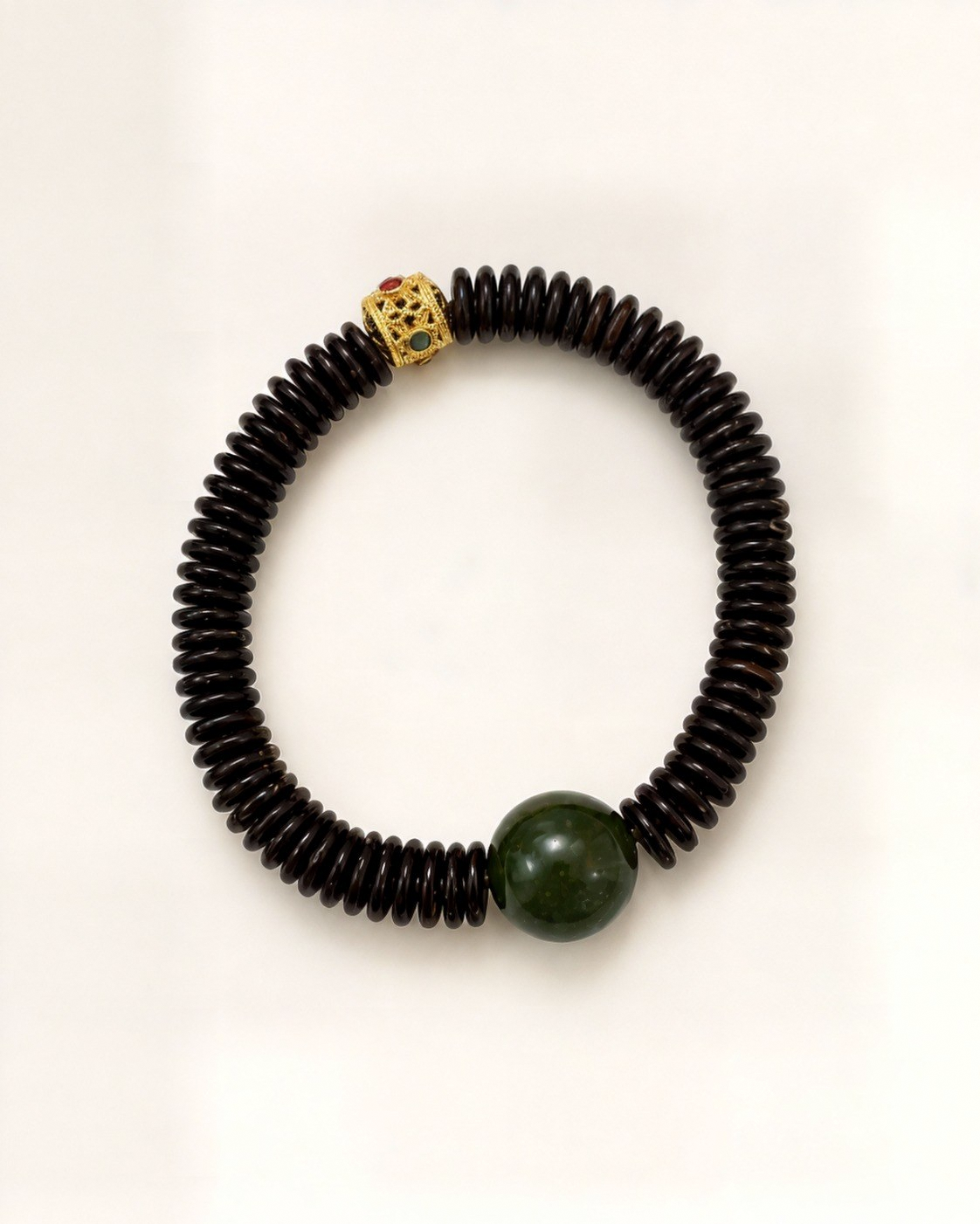 Noche Imperial combines dark bodhi discs with a natural green nephrite jade bead.