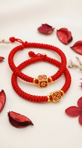Red string bracelet with gold fortune cube charm