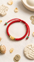 Red string bracelet with gold ingot charm for wealth and prosperity