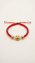 Red string bracelet with gold lucky bag charm