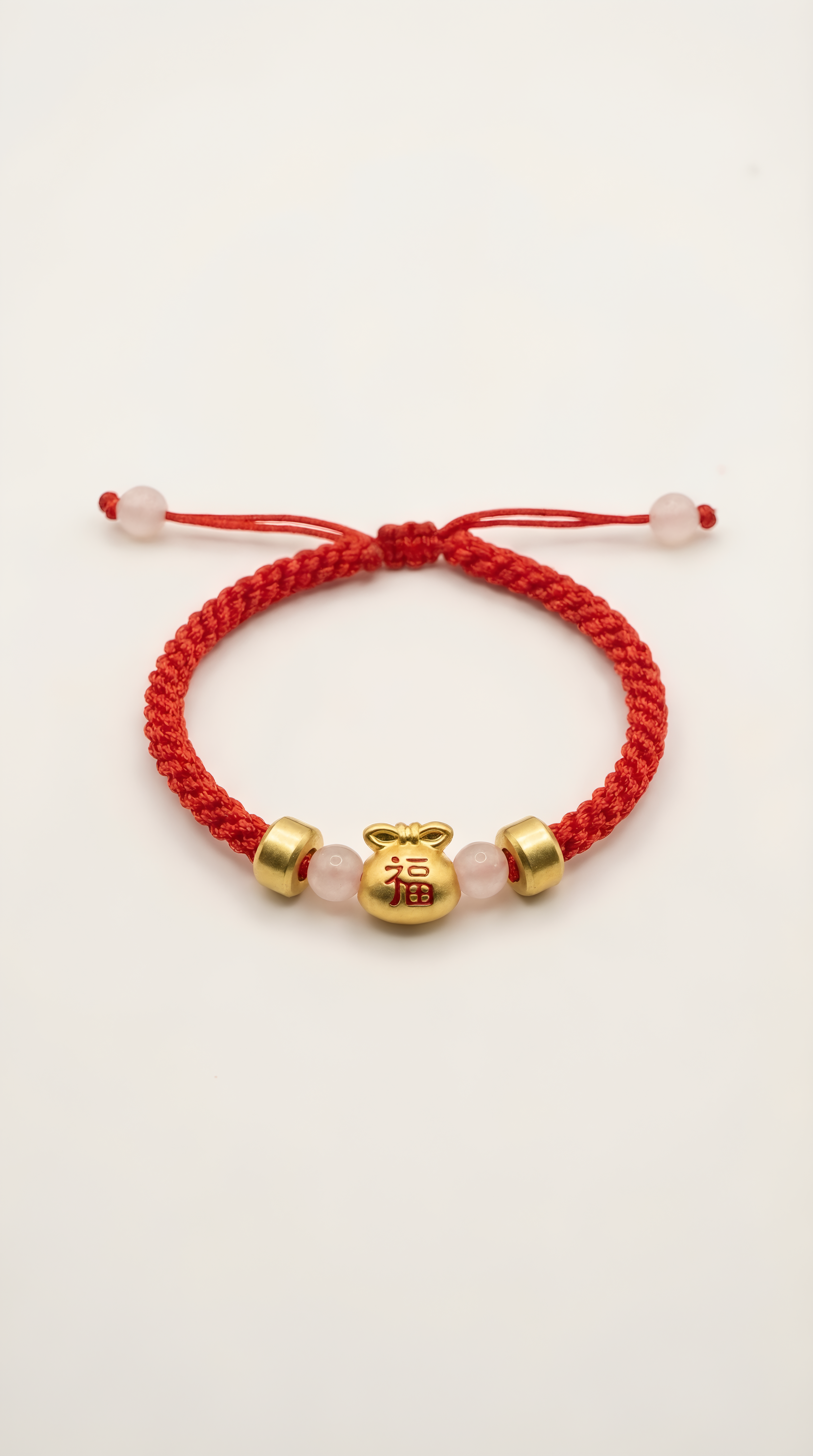 Red string bracelet with gold lucky bag charm