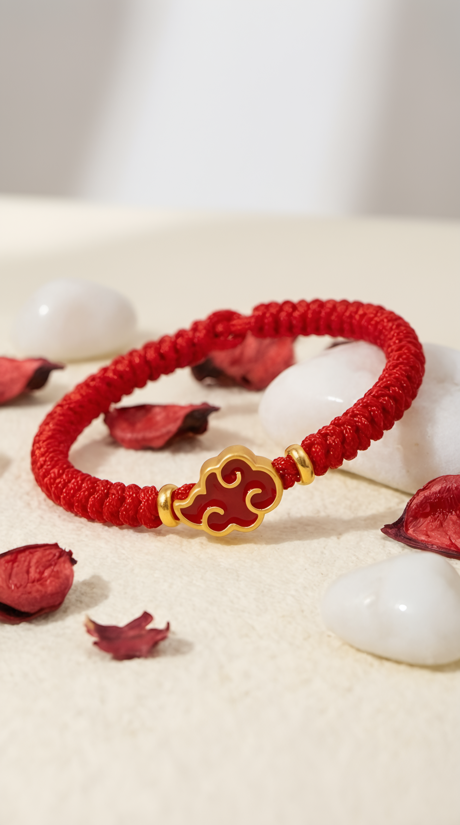 Ruyi cloud charm detail on red string bracelet