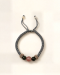 Rocío combines a grey hand-braided silk cord, a pink agate centre bead and two dark green nephrite jade beads.