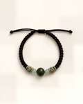 Serena combines a black hand-braided silk cord with a dark green nephrite jade centre bead and two translucent pale green side beads.