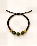 Trío Real combines three green nephrite jade beads and gold-plated bronze openwork ornaments on a black hand-braided silk cord.