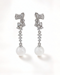 Front view of Gala sterling silver bow earrings with cubic zirconia and white nephrite jade spheres.