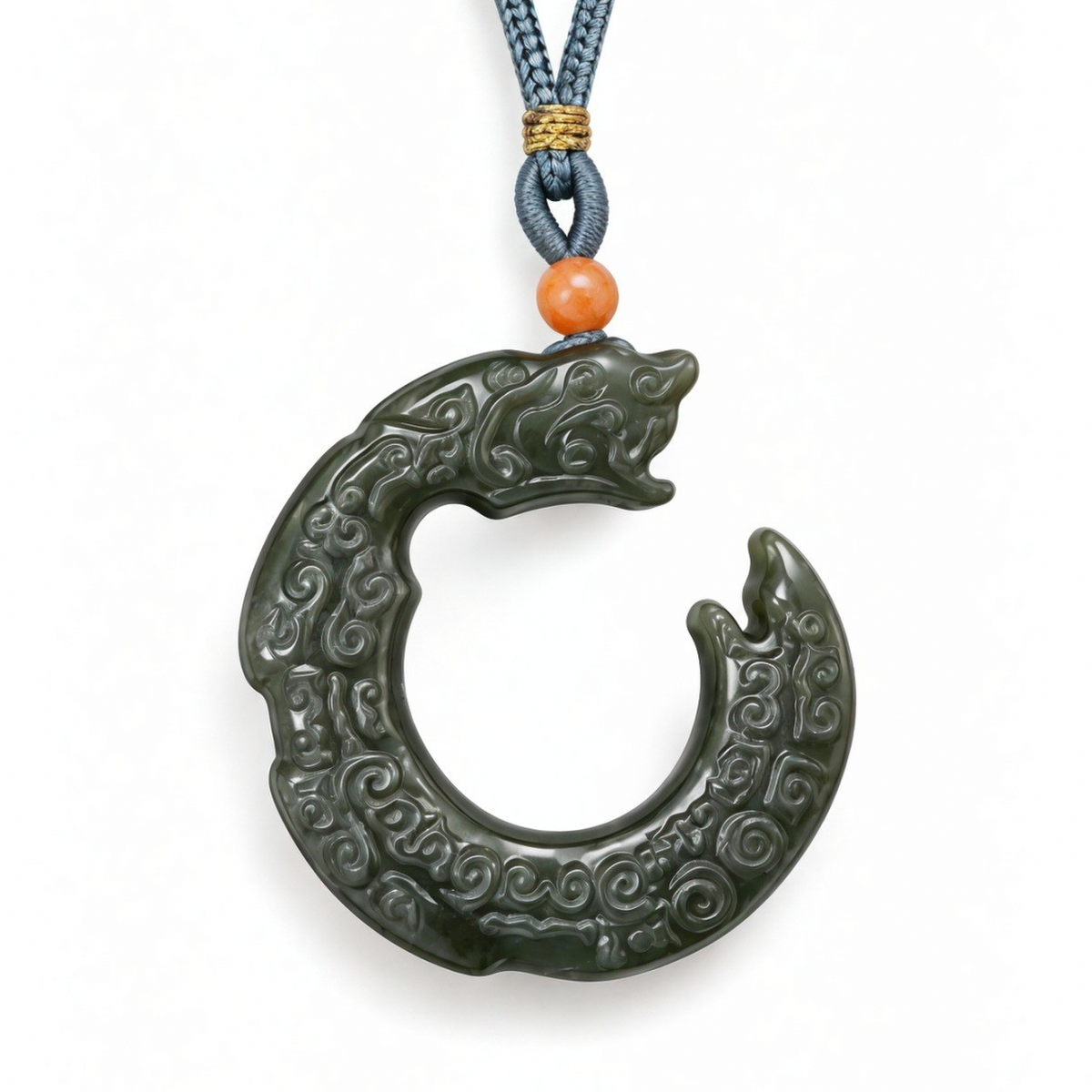 Close-up of the carved dragon on the circular green nephrite jade pendant.