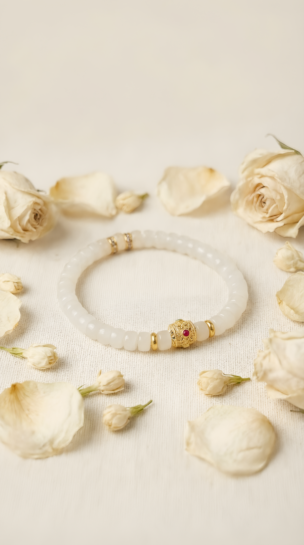 White jade bead bracelet with ruby charm accent