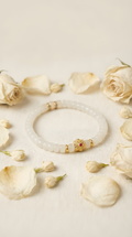 White jade bead bracelet with ruby charm accent