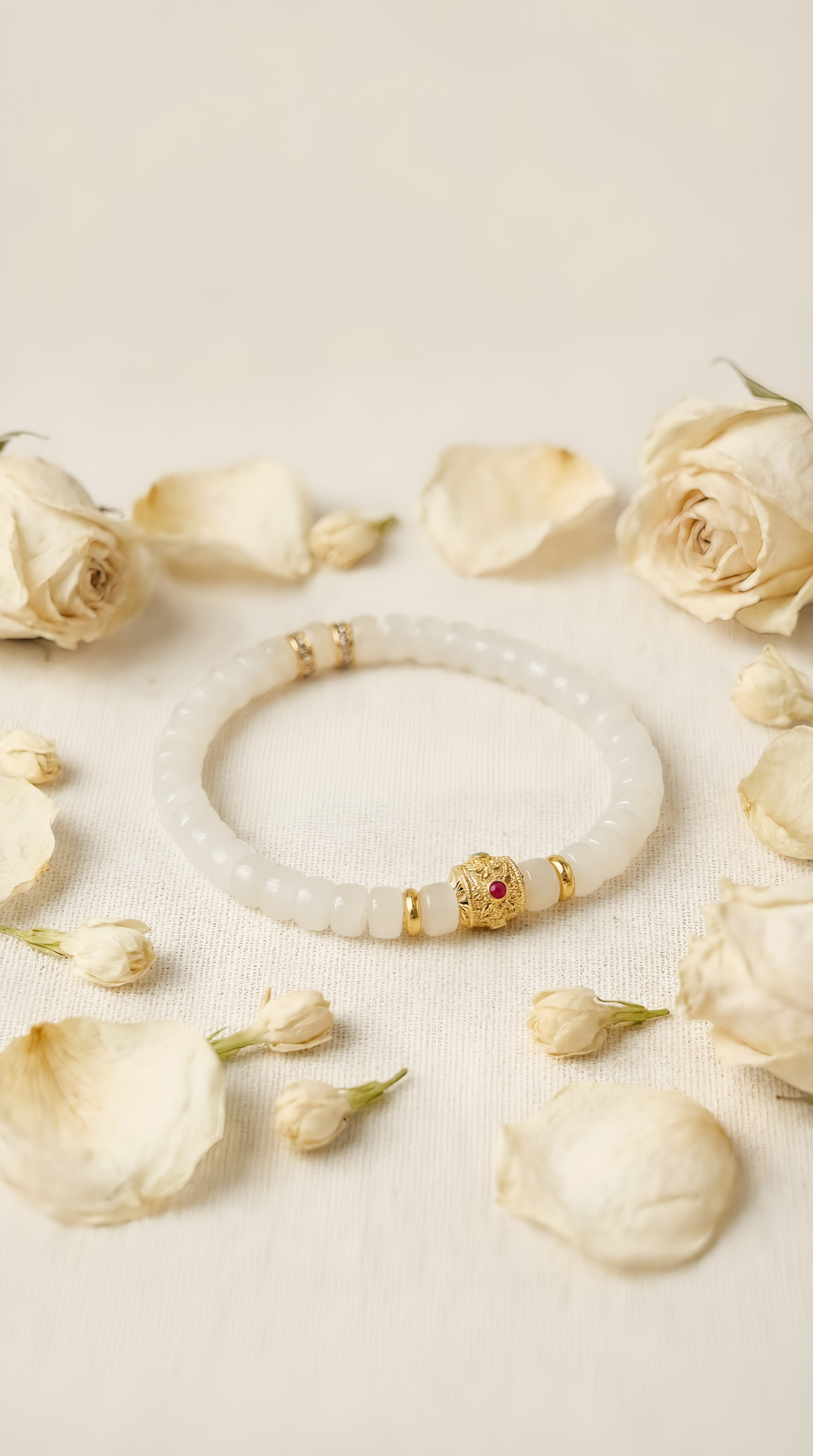 White jade bead bracelet with ruby charm accent