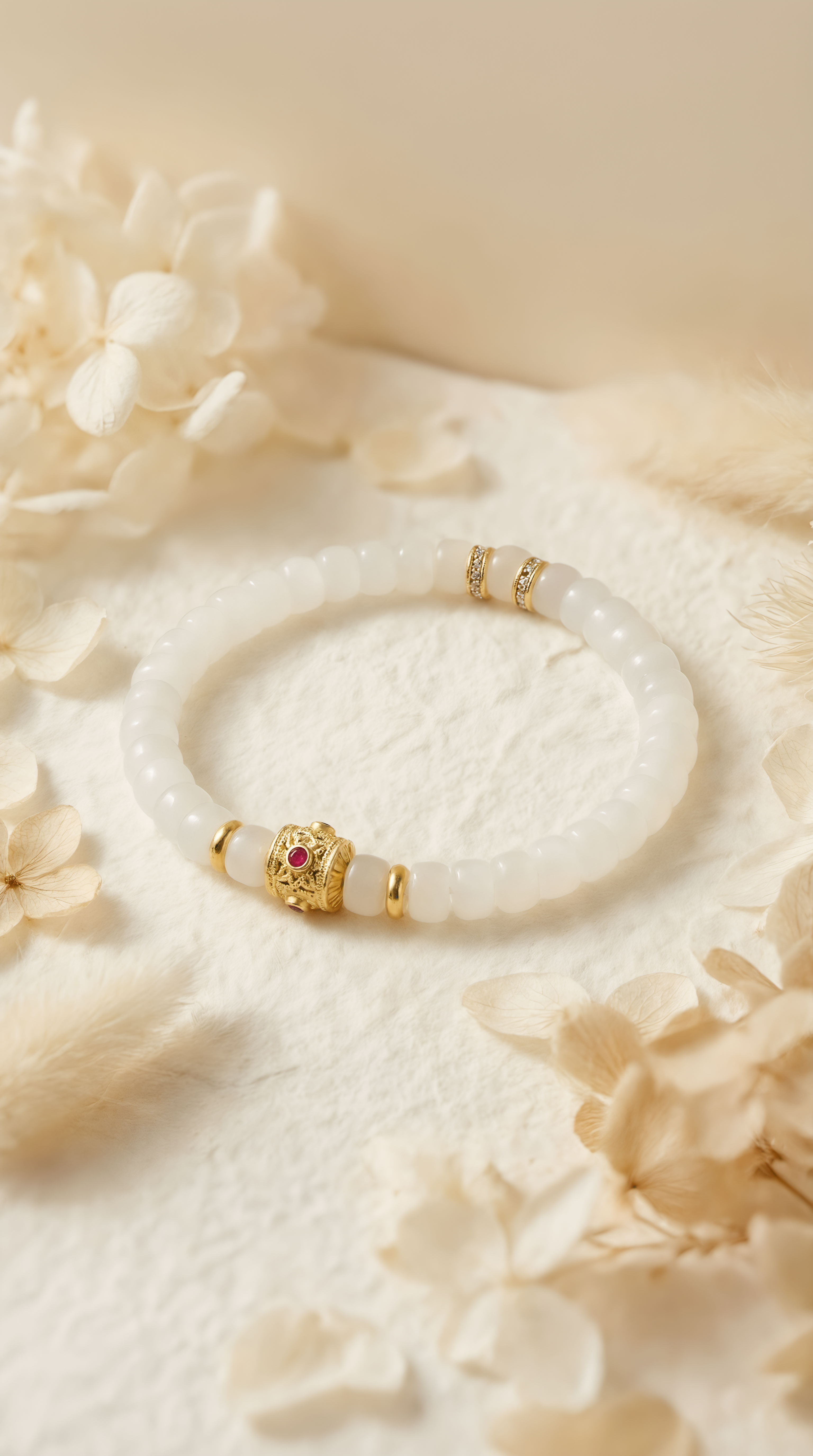 Close-up of white jade bracelet with red ruby charm by Wendy Jewellery