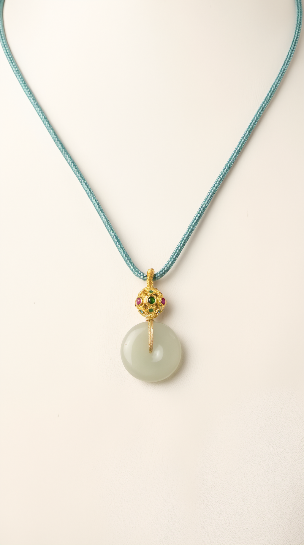 White jade disc pendant necklace detail showing smooth polish